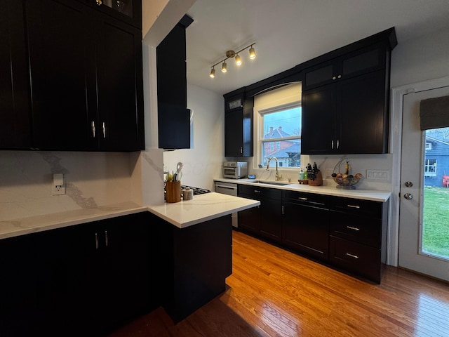 kitchen with light wood-type flooring and sink