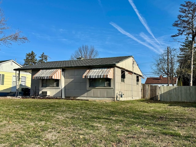 exterior space with cooling unit and a yard