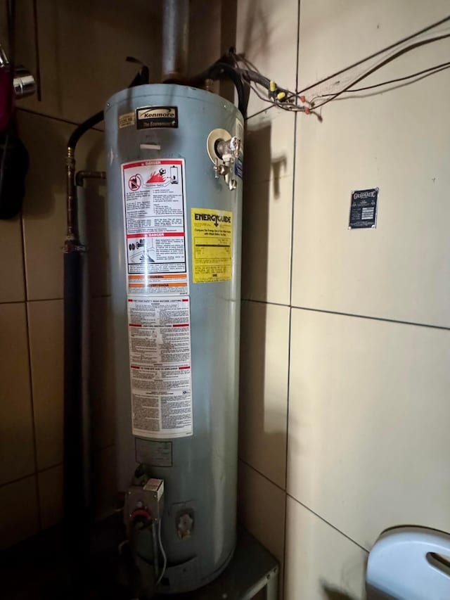 utility room with gas water heater