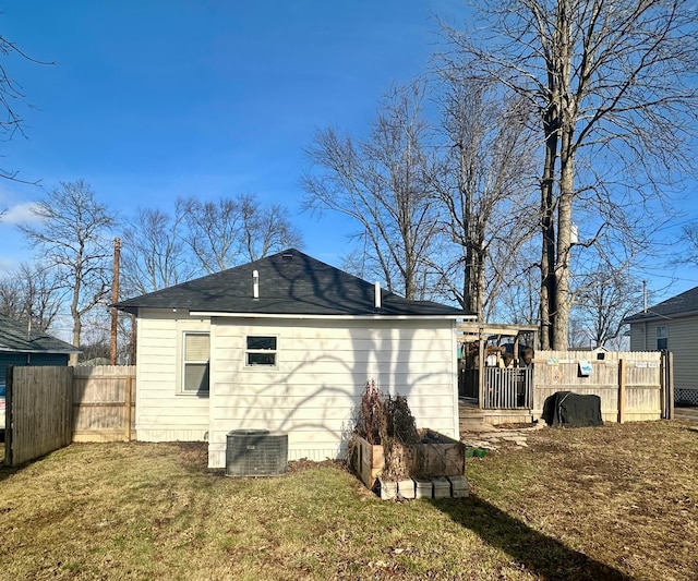 rear view of property featuring a lawn