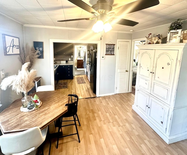 dining space with ceiling fan, light hardwood / wood-style floors, and crown molding