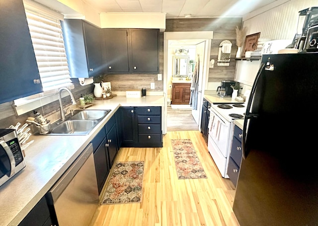 kitchen featuring appliances with stainless steel finishes, light hardwood / wood-style flooring, and sink