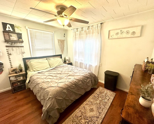 bedroom with ceiling fan and dark wood-type flooring