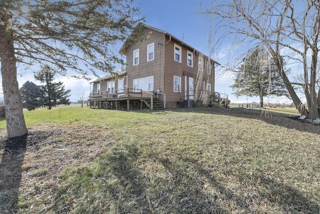 rear view of house featuring central AC, a yard, and a deck