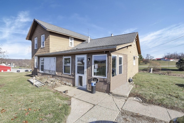 rear view of property with a lawn