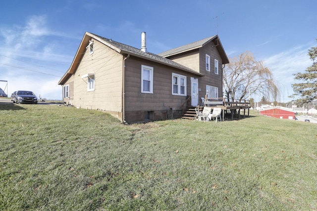 back of property featuring a deck and a yard