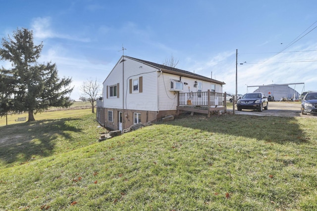 view of home's exterior featuring a yard and a wooden deck