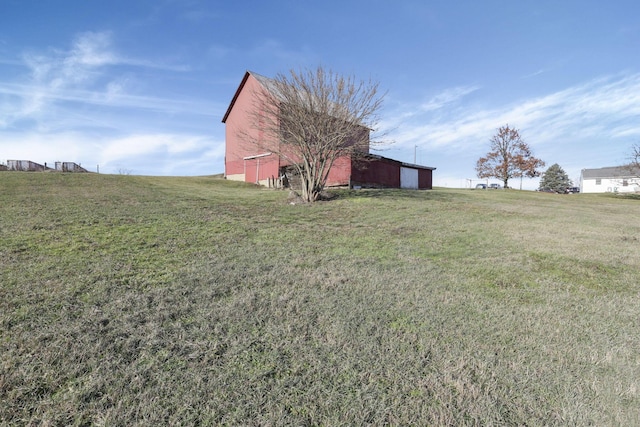 view of yard with an outbuilding and a rural view