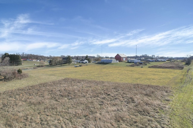 view of yard featuring a rural view and an outdoor structure