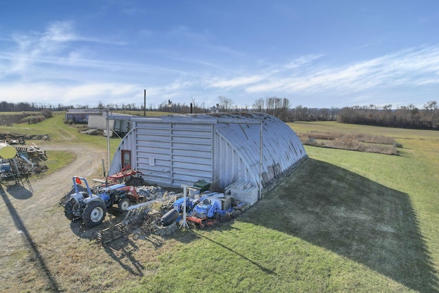 view of outbuilding featuring a yard and a rural view