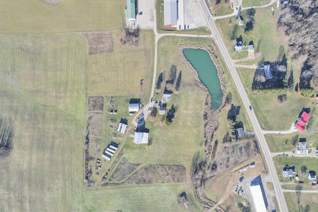 birds eye view of property with a rural view and a water view