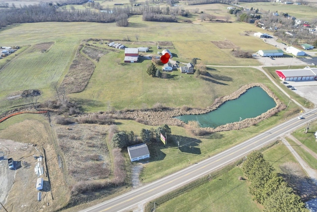 birds eye view of property featuring a water view and a rural view