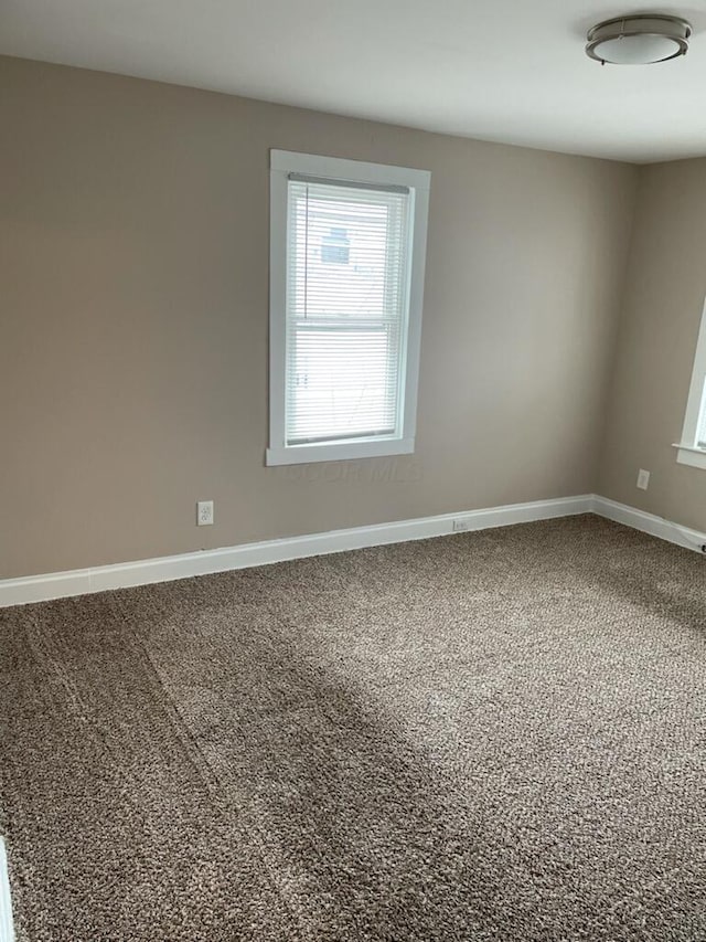 unfurnished room with carpet flooring