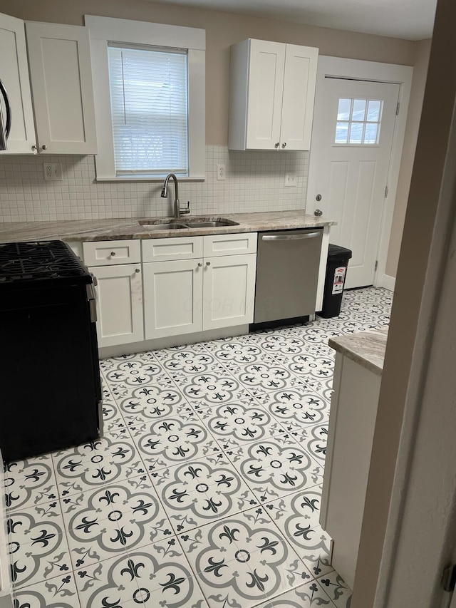 kitchen with white cabinetry, sink, dishwasher, and light tile patterned flooring