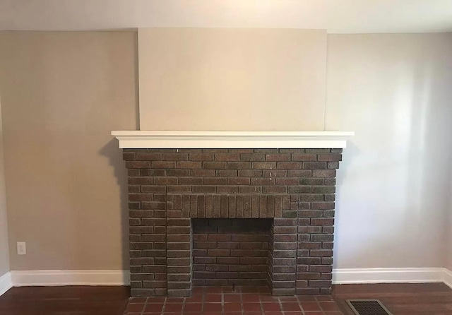 interior details with a brick fireplace and wood-type flooring