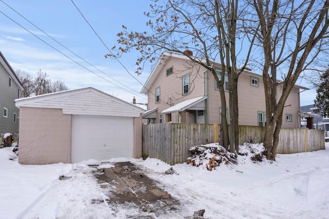 view of snowy exterior with a garage