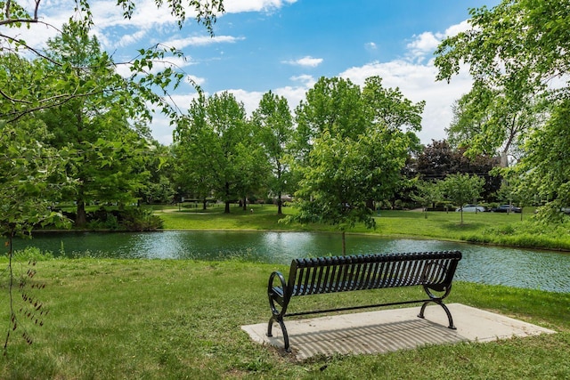 view of home's community featuring a water view and a lawn