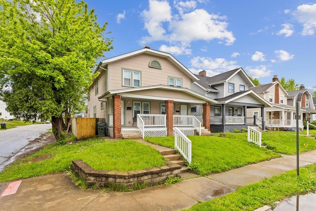 1146 S Champion Ave Unit 1148, Columbus, OH 43206 - view of front facade featuring covered porch and brick siding