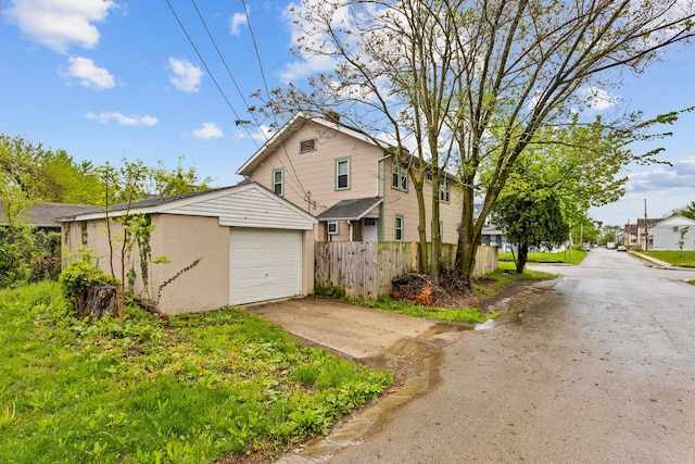 1146 S Champion Ave Unit 1148, Columbus, OH 43206 - view of home's exterior with driveway, fence, an outbuilding, and a garage