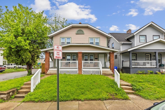 1146 S Champion Ave Unit 1148, Columbus, OH 43206 - view of front facade with covered porch and a front lawn