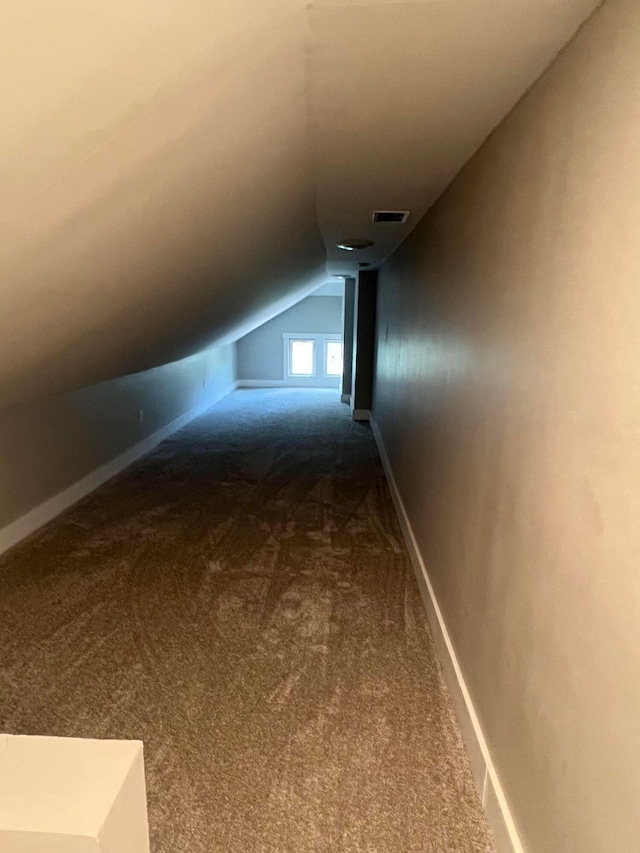 bonus room featuring lofted ceiling and carpet floors