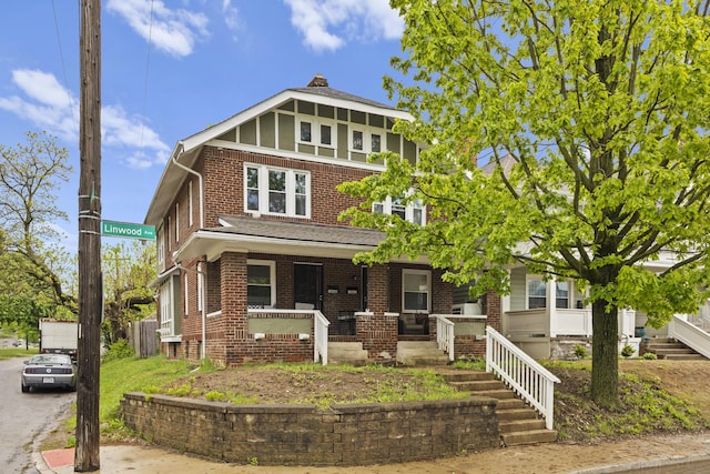 1060-1062 Linwood Ave, Columbus, OH 43206 - view of front of house featuring brick siding, a porch, and a chimney
