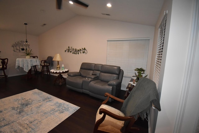 living room with dark hardwood / wood-style flooring and vaulted ceiling