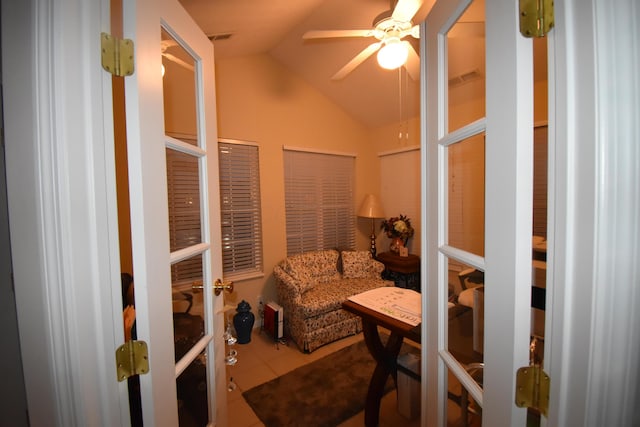 living area featuring vaulted ceiling, ceiling fan, tile patterned flooring, and french doors