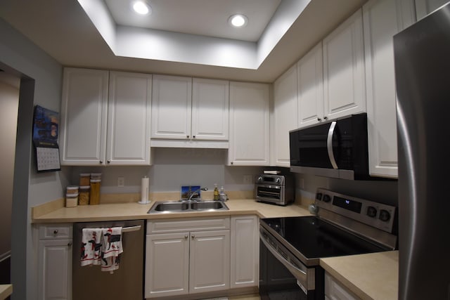 kitchen with white cabinetry, appliances with stainless steel finishes, and sink