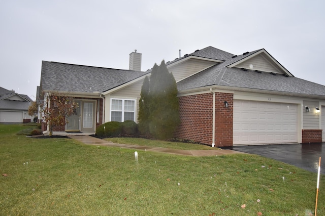 view of front of property featuring a garage and a front yard