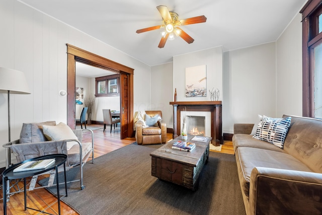 living room with hardwood / wood-style flooring and ceiling fan