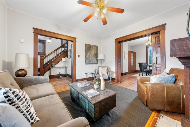 living room with ceiling fan and light hardwood / wood-style flooring