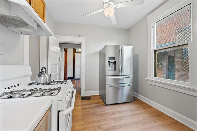 kitchen with ventilation hood, white range with gas stovetop, ceiling fan, light hardwood / wood-style floors, and stainless steel refrigerator with ice dispenser