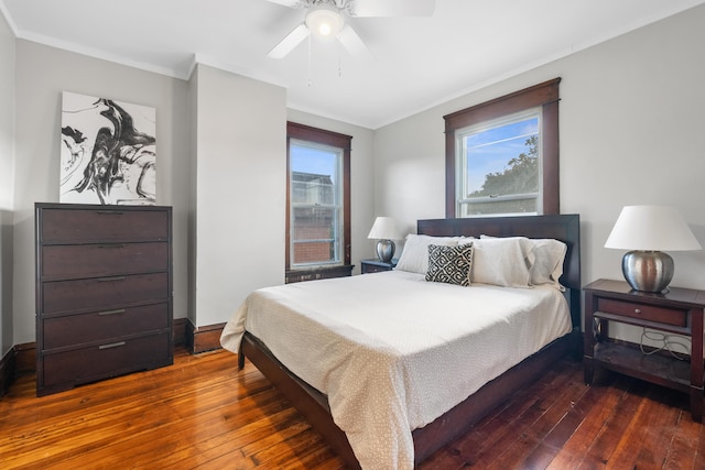 bedroom featuring dark hardwood / wood-style flooring, crown molding, and ceiling fan