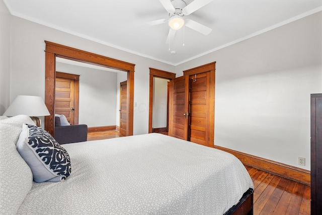 bedroom featuring ceiling fan, ornamental molding, and hardwood / wood-style floors