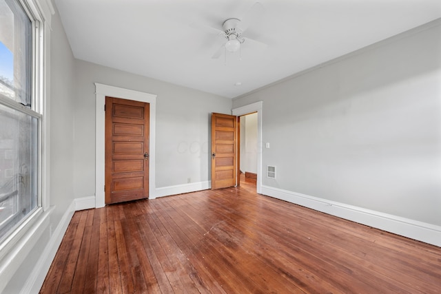 unfurnished bedroom featuring hardwood / wood-style flooring, a closet, and ceiling fan