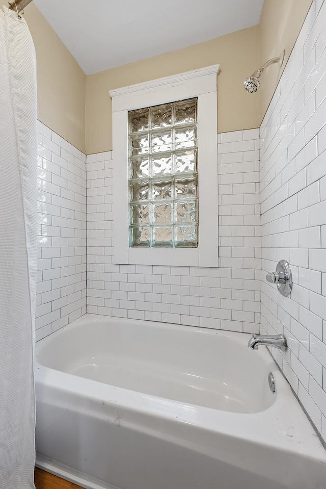 bathroom featuring shower / bathtub combination with curtain