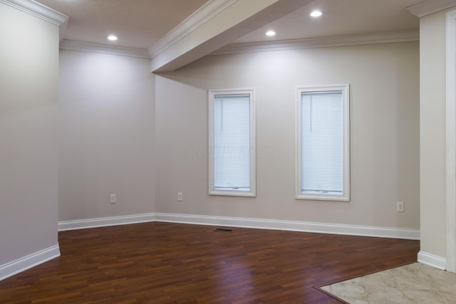 unfurnished room featuring visible vents, baseboards, and wood finished floors