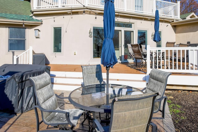 wooden deck featuring a patio area and outdoor dining space