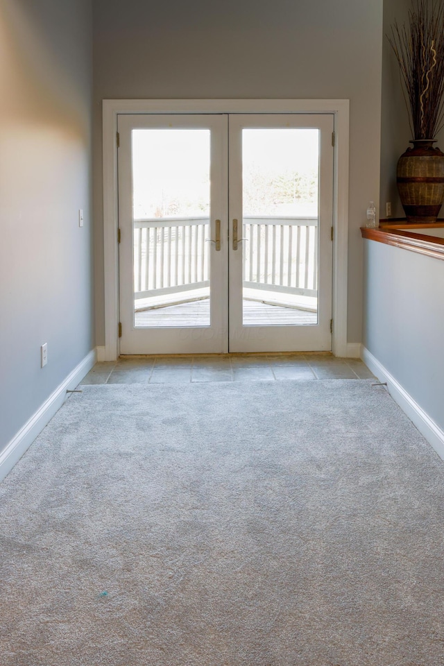 empty room with plenty of natural light, carpet, and baseboards