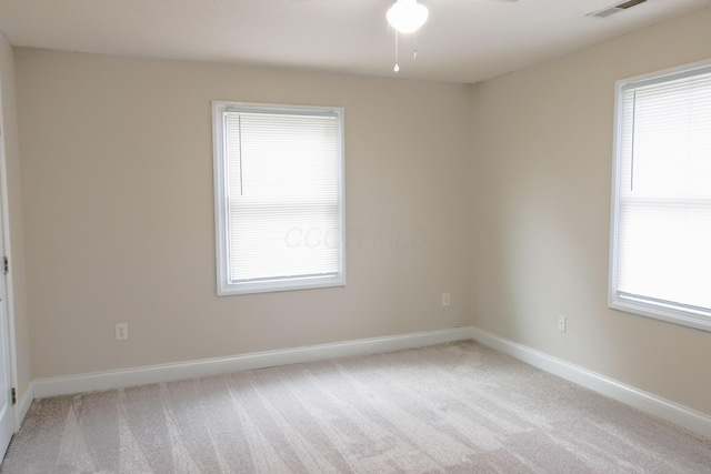 empty room with visible vents, baseboards, and carpet