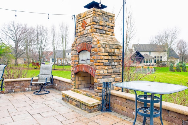 view of patio / terrace featuring an outdoor stone fireplace