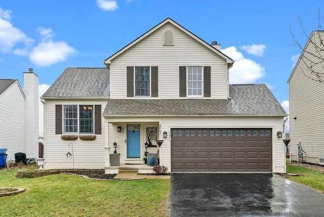 view of front of property featuring a front yard and a garage