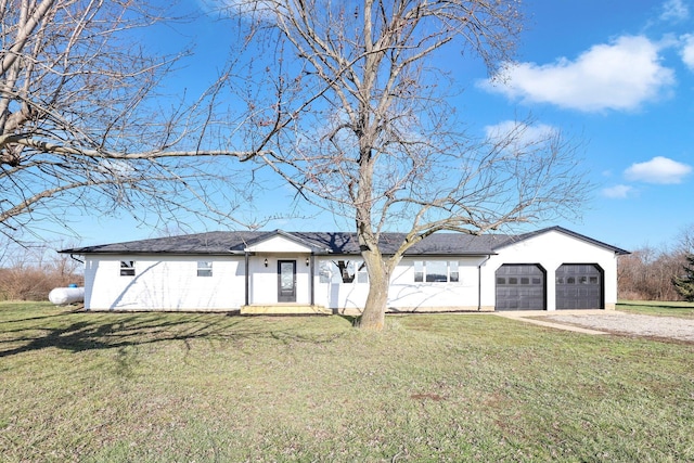 ranch-style house with a garage and a front lawn