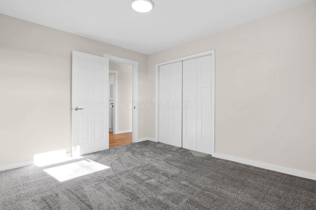 unfurnished bedroom with a closet and carpet floors