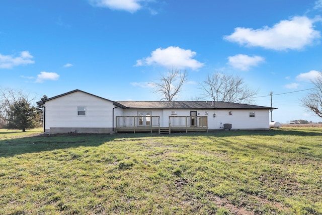 back of house with a yard, central air condition unit, and a wooden deck