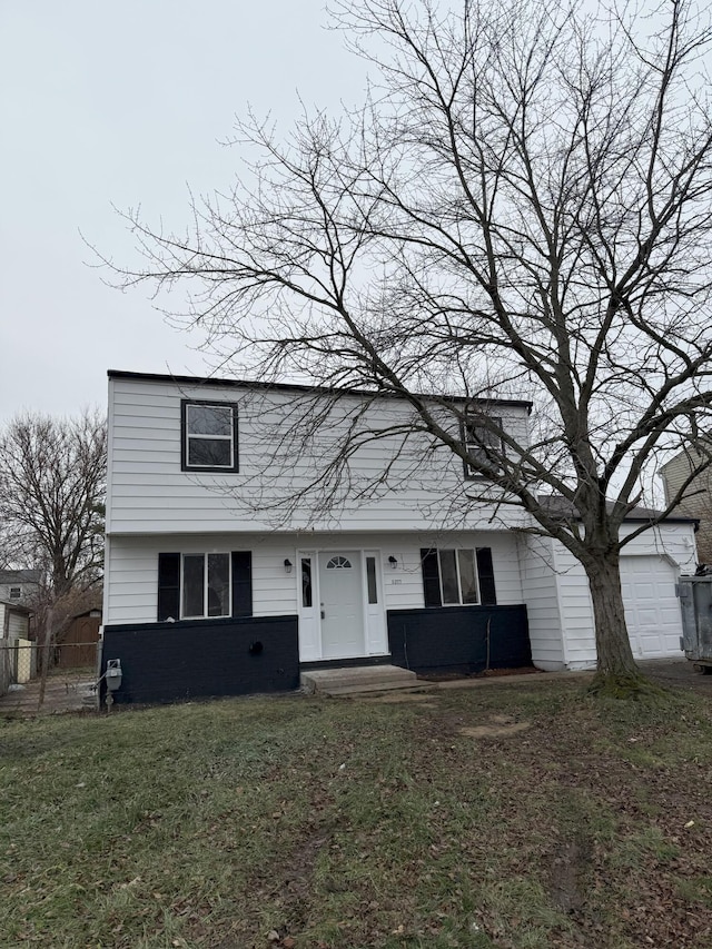 view of front of property with a front yard and a garage