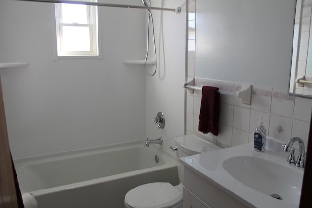 full bathroom featuring washtub / shower combination, vanity, toilet, and tile walls