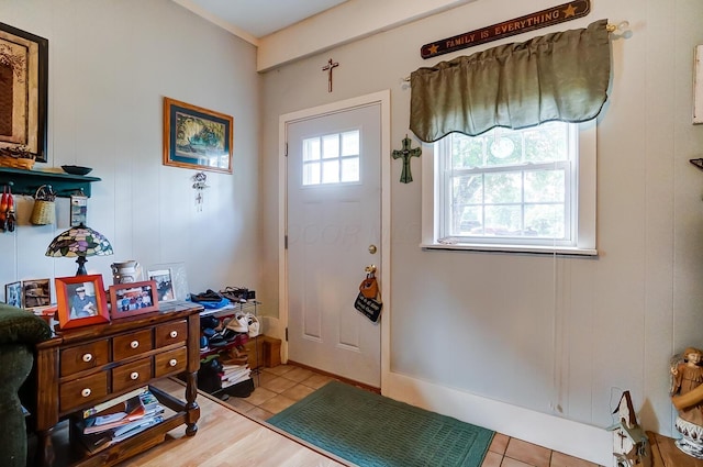 doorway to outside featuring light tile patterned flooring