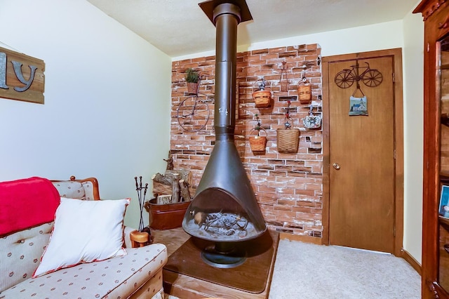 sitting room with carpet flooring and a wood stove